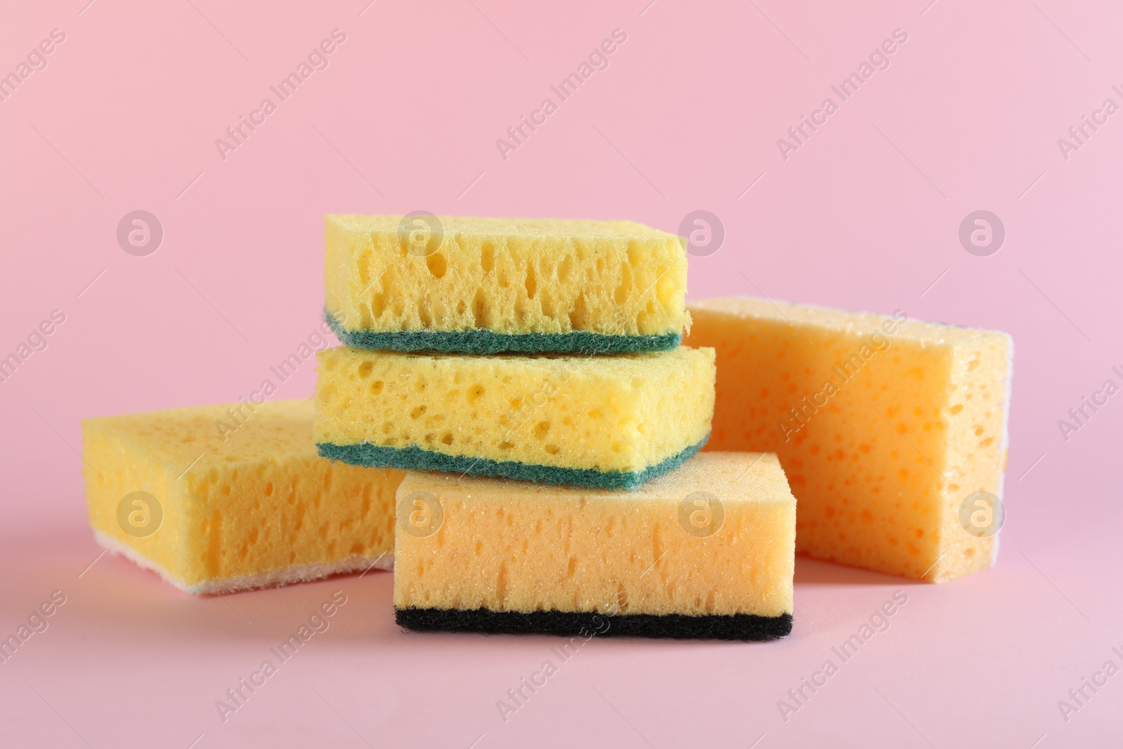 Photo of Different clean sponges on pink background, closeup