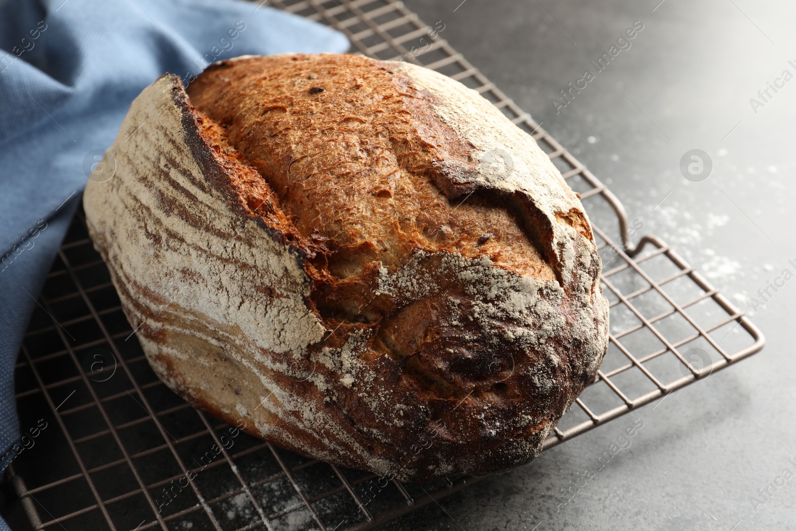 Photo of Freshly baked bread on grey table, closeup