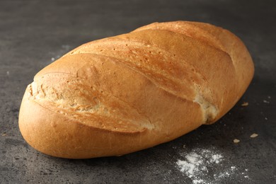 Photo of Freshly baked bread on grey table, closeup