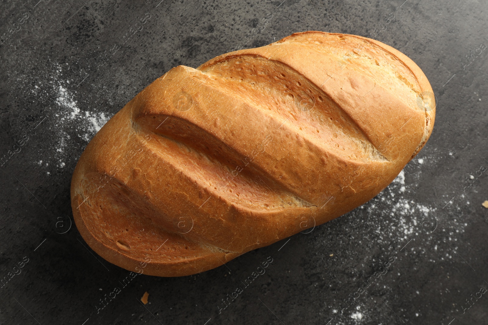 Photo of Freshly baked bread on grey table, top view