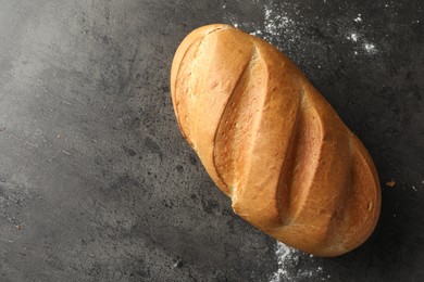 Photo of Freshly baked bread on grey table, top view. Space for text