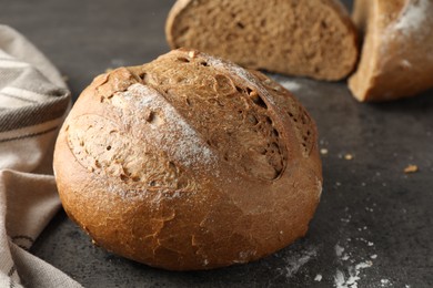 Photo of Freshly baked bread on grey table, closeup