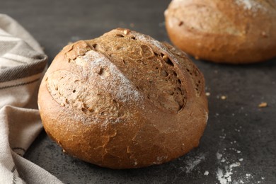 Photo of Freshly baked bread on grey table, closeup