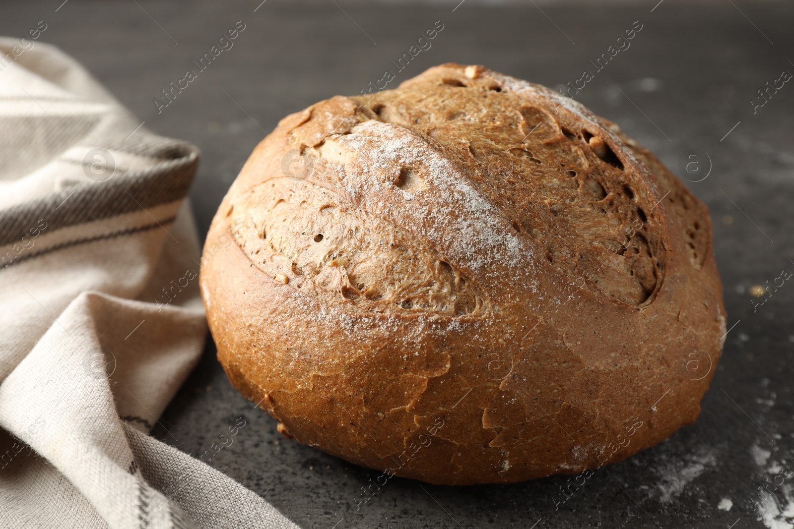 Photo of Freshly baked bread on grey table, closeup