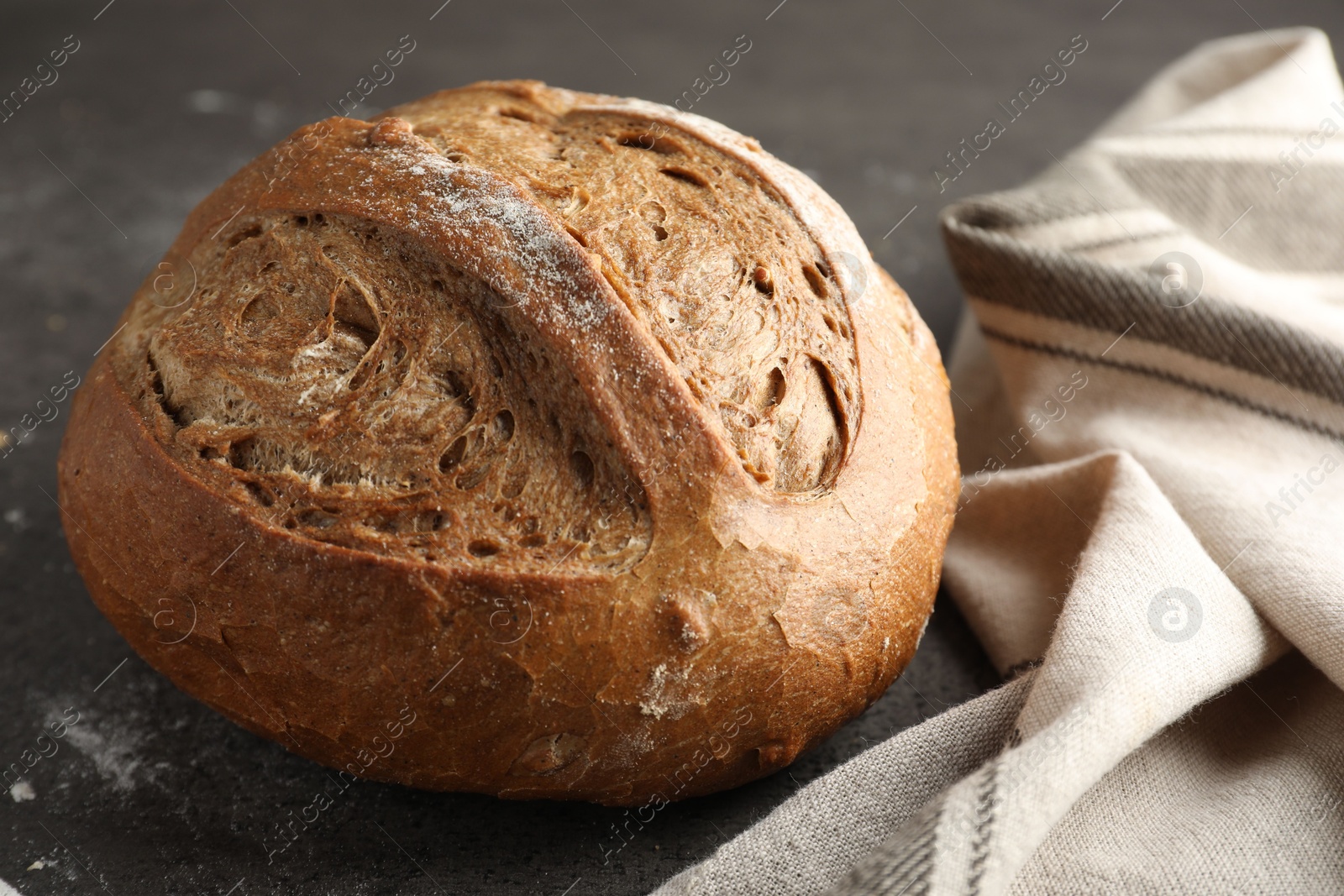 Photo of Freshly baked bread on grey table, closeup