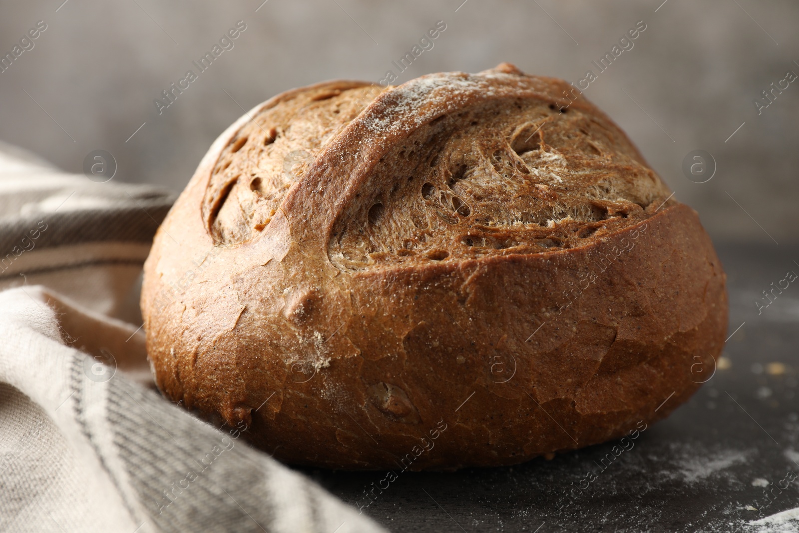 Photo of Freshly baked bread on grey table, closeup