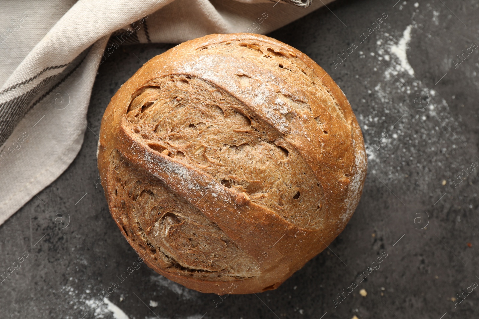 Photo of Freshly baked bread on grey table, top view