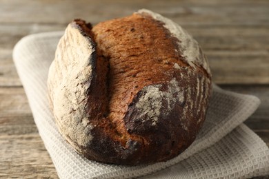 Photo of Freshly baked bread on wooden table, closeup