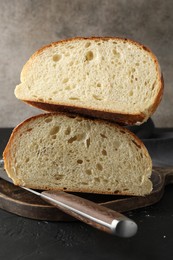 Photo of Pieces of fresh bread on black table, closeup