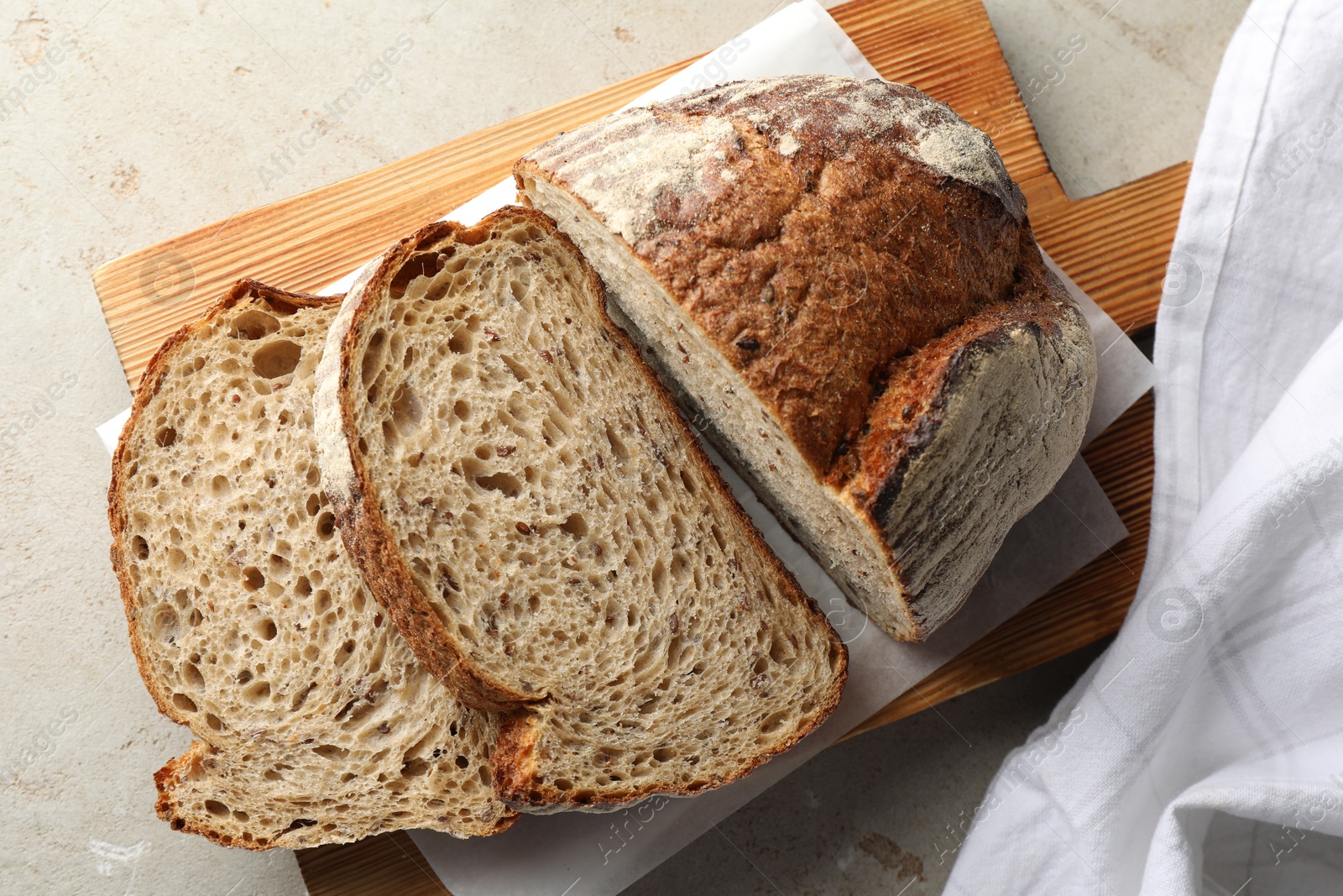 Photo of Cut loaf of fresh bread on table, top view