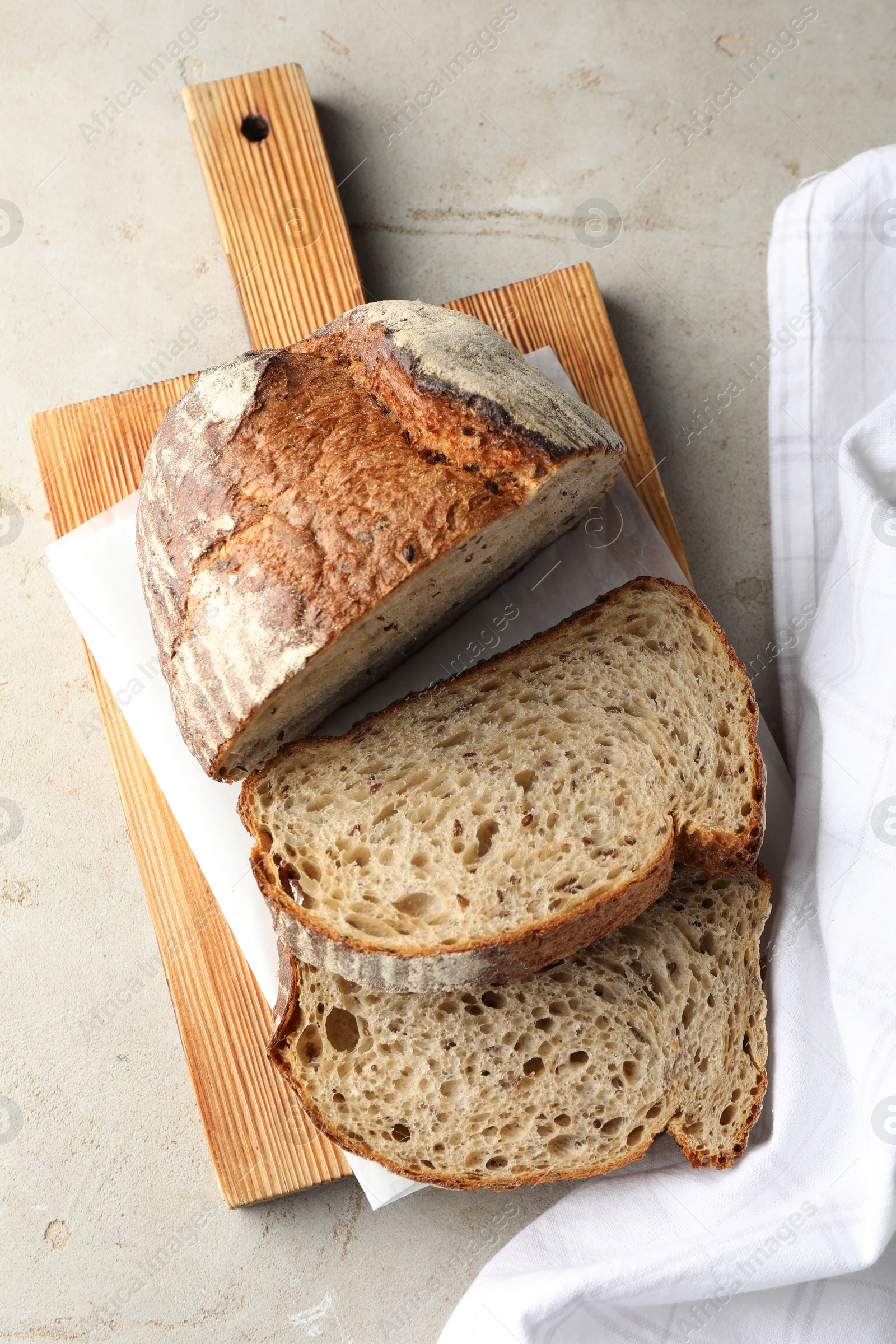 Photo of Cut loaf of fresh bread on table, top view