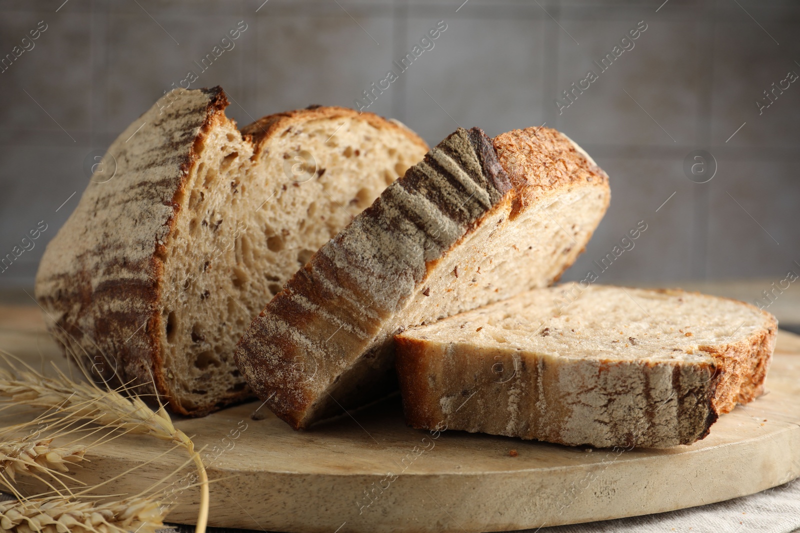 Photo of Cut loaf of fresh bread on table, closeup