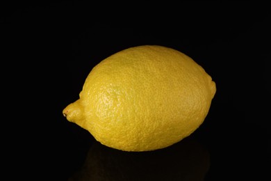 Photo of One fresh lemon on black background, closeup