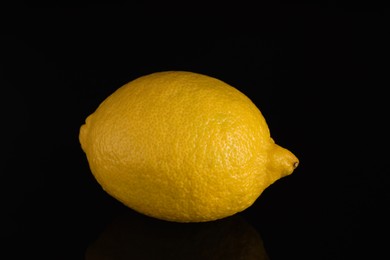 Photo of One fresh lemon on black background, closeup