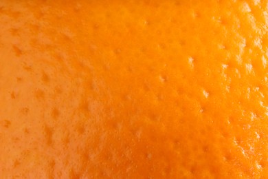 Photo of Fresh orange peel as background, macro view