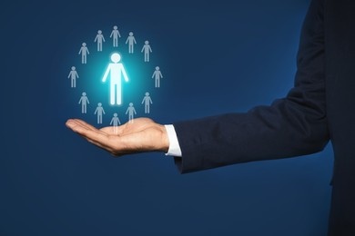 Image of Human resource. Businessman choosing one virtual figure among others on blue background, closeup