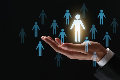 Image of Human resource. Businessman choosing one virtual figure among others on black background, closeup