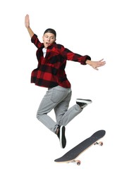 Image of Handsome man with skateboard in air on white background. Performing trick