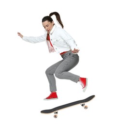 Image of Beautiful woman with skateboard in air on white background. Performing trick