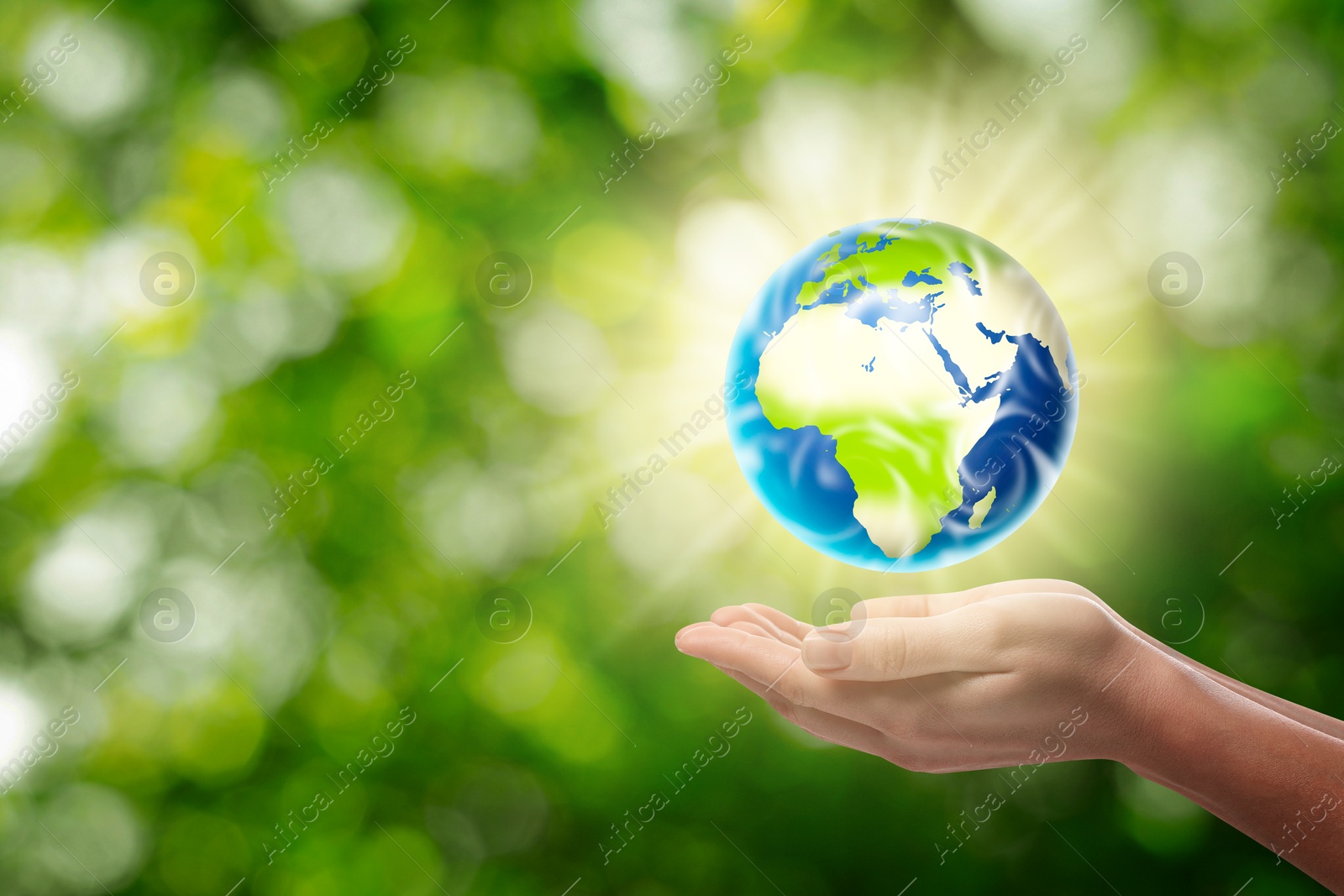 Image of Save Earth. Woman holding glowing globe outdoors, closeup