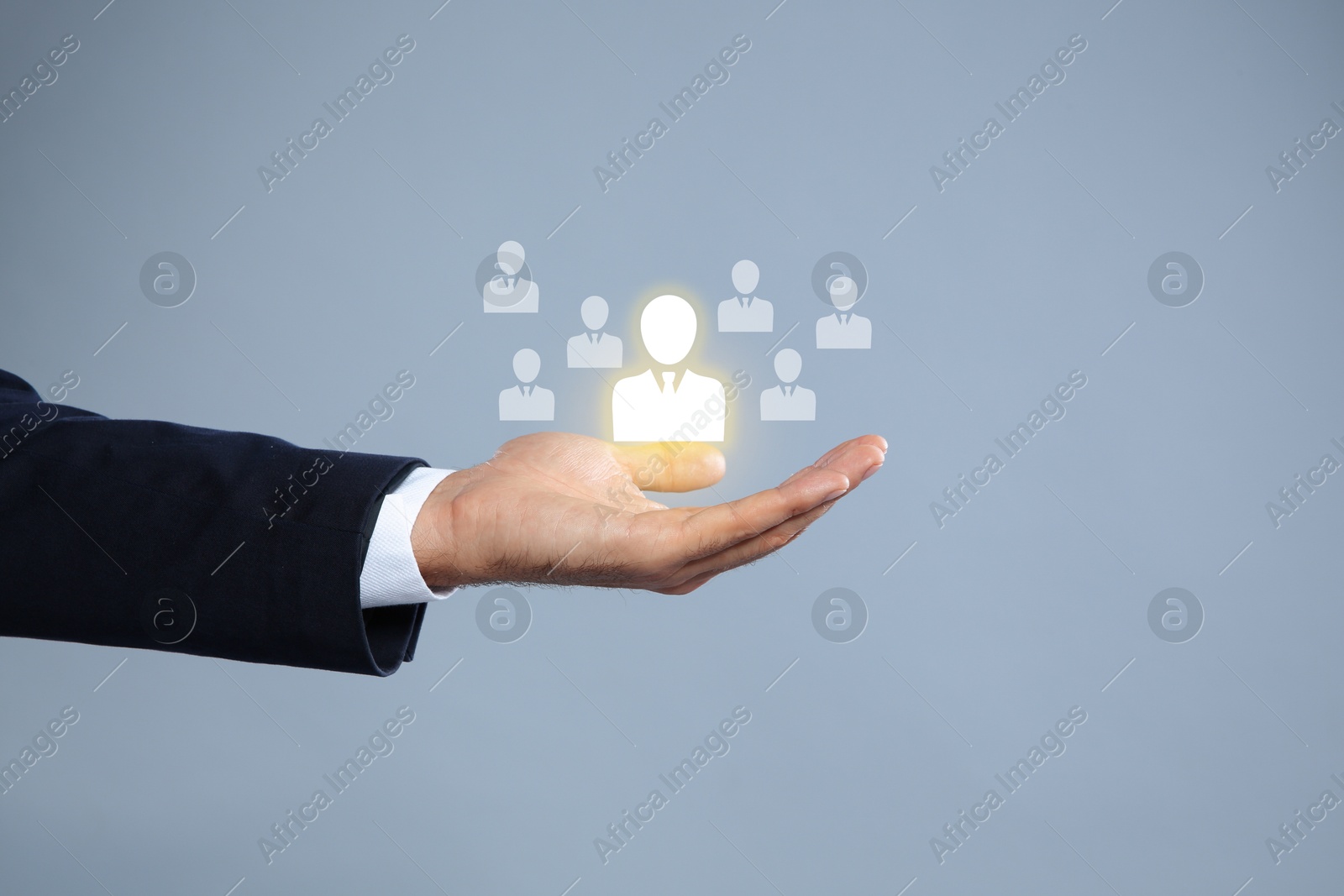 Image of Human resource. Businessman choosing one virtual figure among others on grey background, closeup