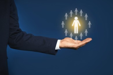 Image of Human resource. Businessman choosing one virtual figure among others on blue background, closeup