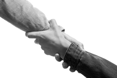 Image of Help and support. People holding hands on white background, closeup. Toned in black and white