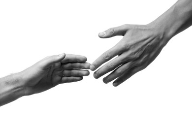 Image of Man giving helping hand to friend on white background, closeup. Toned in black and white