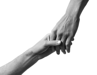 Image of Help and support. People holding hands on white background, closeup. Toned in black and white