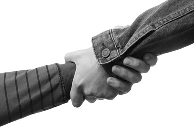 Image of Help and support. People holding hands on white background, closeup. Toned in black and white