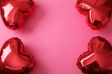 Photo of Red heart shaped balloons on pink background, flat lay with space for text. Saint Valentine's day celebration