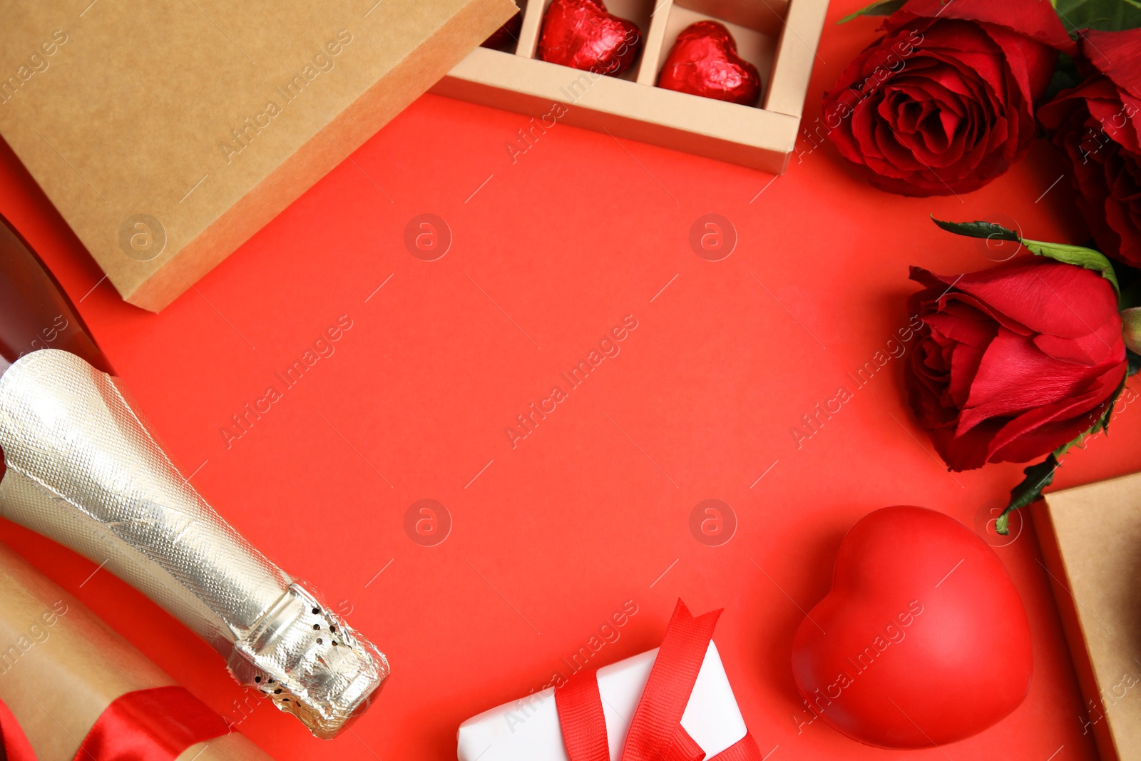 Photo of Flat lay composition with heart shaped chocolate candies on red background, space for text. Valentine's day celebration