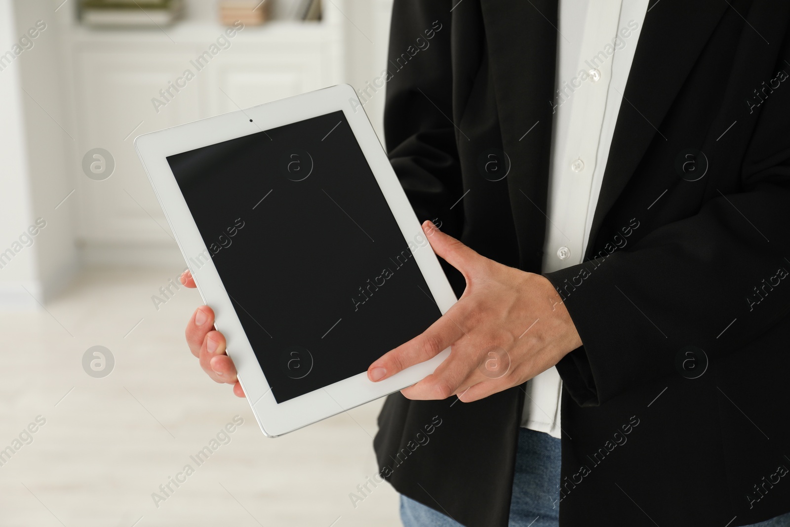 Photo of Businesswoman with tablet indoors, closeup. Modern technology