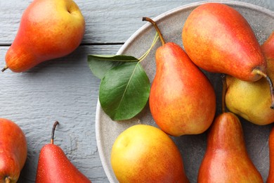 Photo of Ripe juicy pears on grey wooden table, flat lay