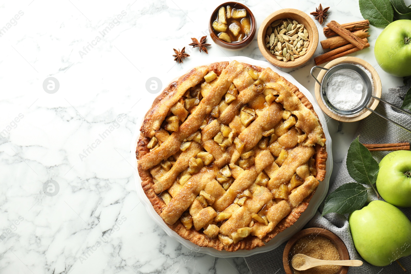 Photo of Homemade apple pie and ingredients on white marble table, flat lay. Space for text