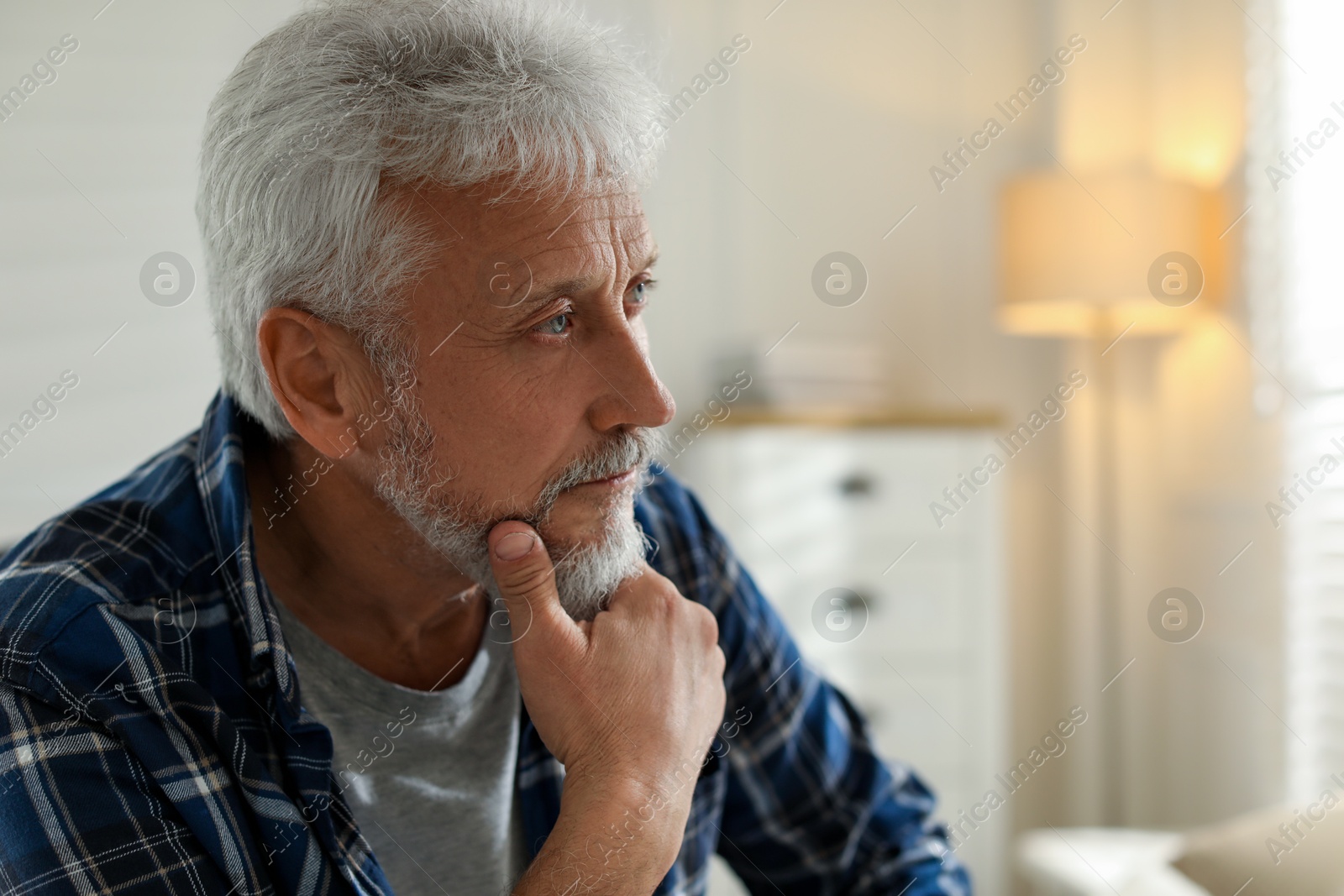 Photo of Sad senior man feeling lonely at home. Space for text