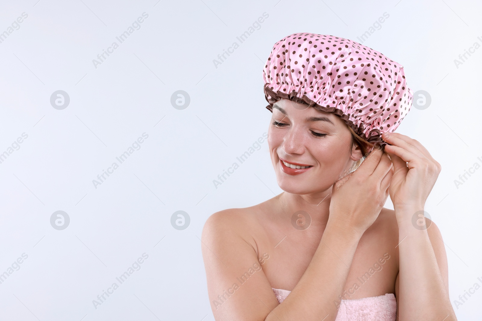 Photo of Woman wearing shower cap on white background, space for text