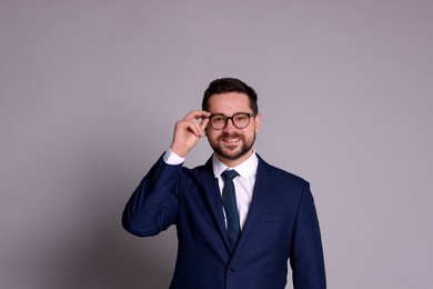 Photo of Portrait of banker in glasses on grey background