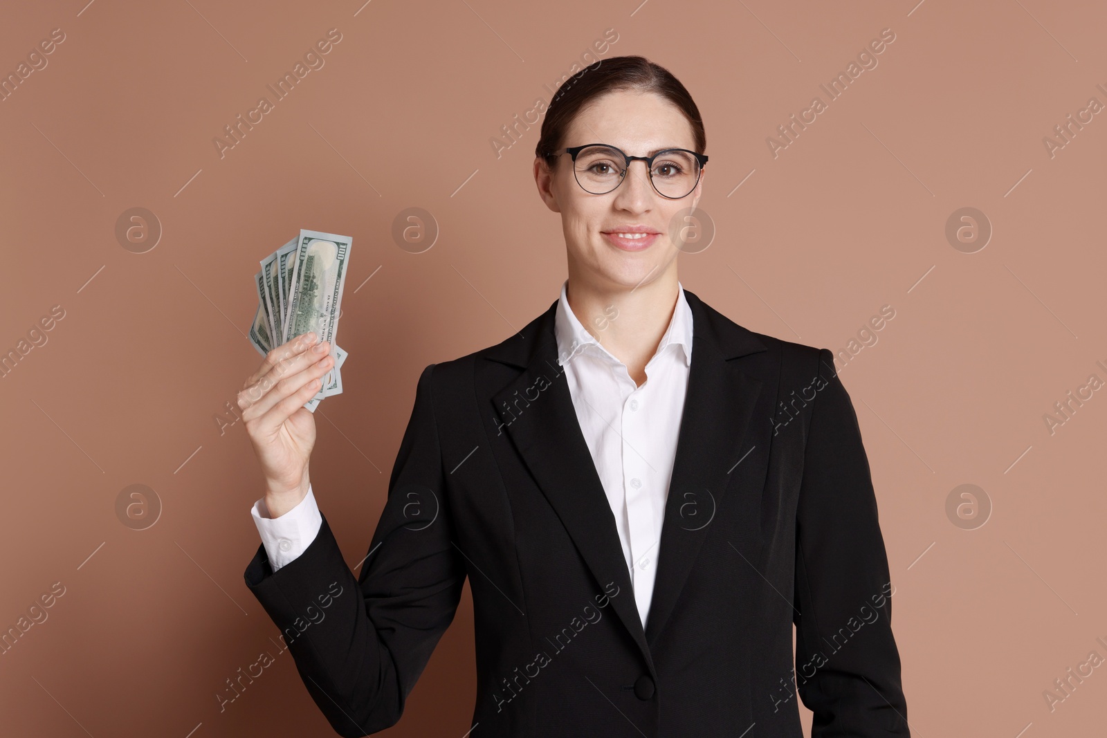 Photo of Banker with dollar banknotes on brown background