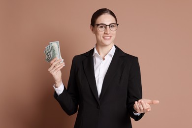 Photo of Banker with dollar banknotes on brown background