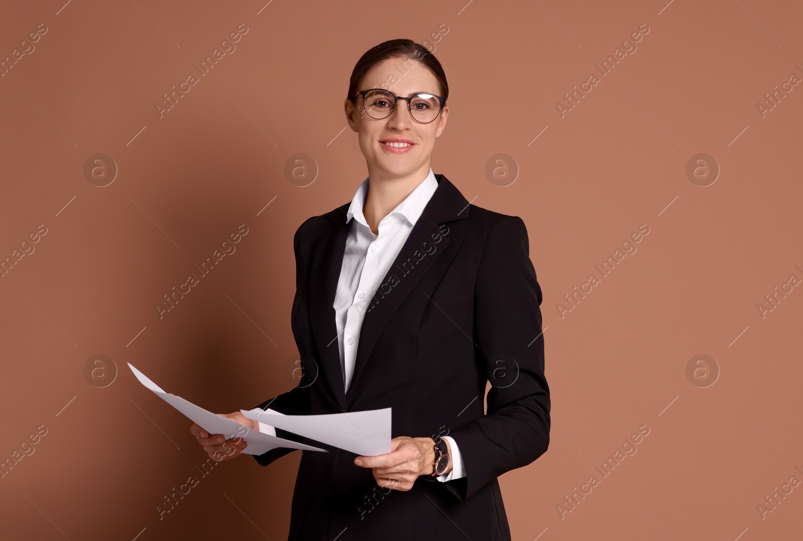 Photo of Portrait of banker with documents on brown background