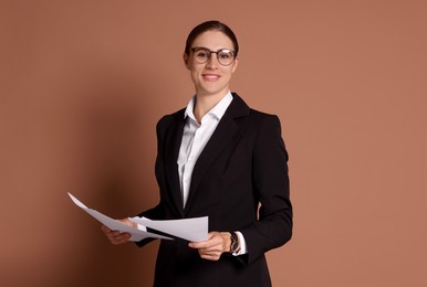 Photo of Portrait of banker with documents on brown background