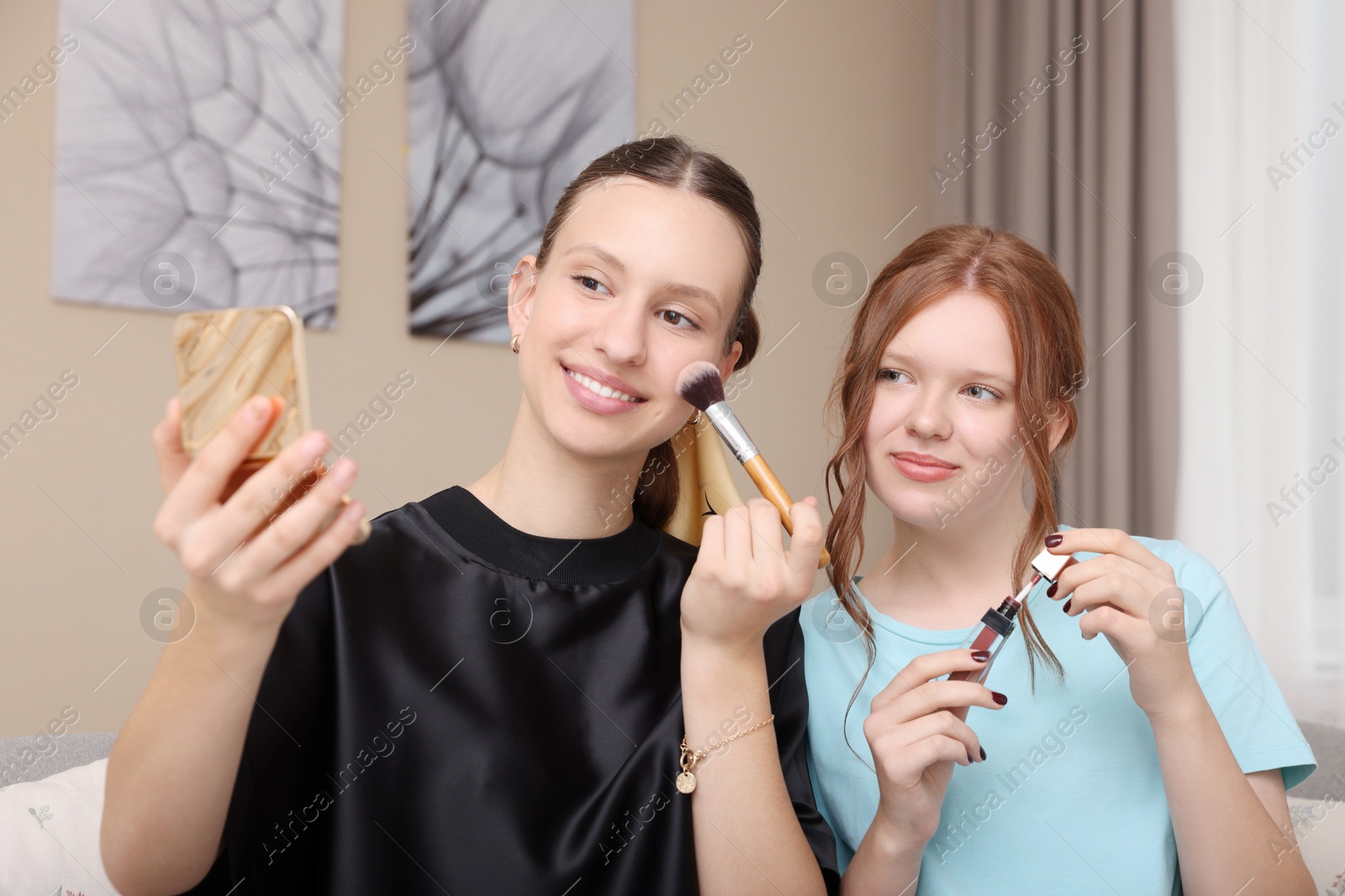 Photo of Beautiful teenage girls doing makeup at home