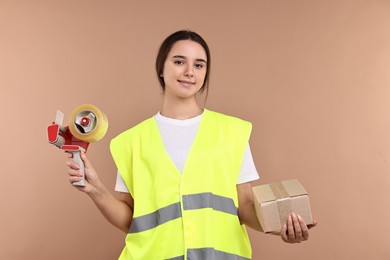 Photo of Girl in uniform with adhesive tape and parcel on pale brown background. Work for teenagers