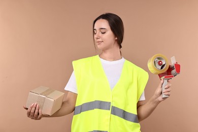 Photo of Girl in uniform with adhesive tape and parcel on pale brown background. Work for teenagers