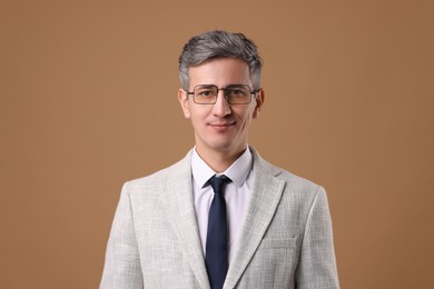 Photo of Portrait of businessman in glasses on brown background