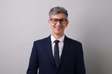 Photo of Portrait of businessman in glasses on light grey background