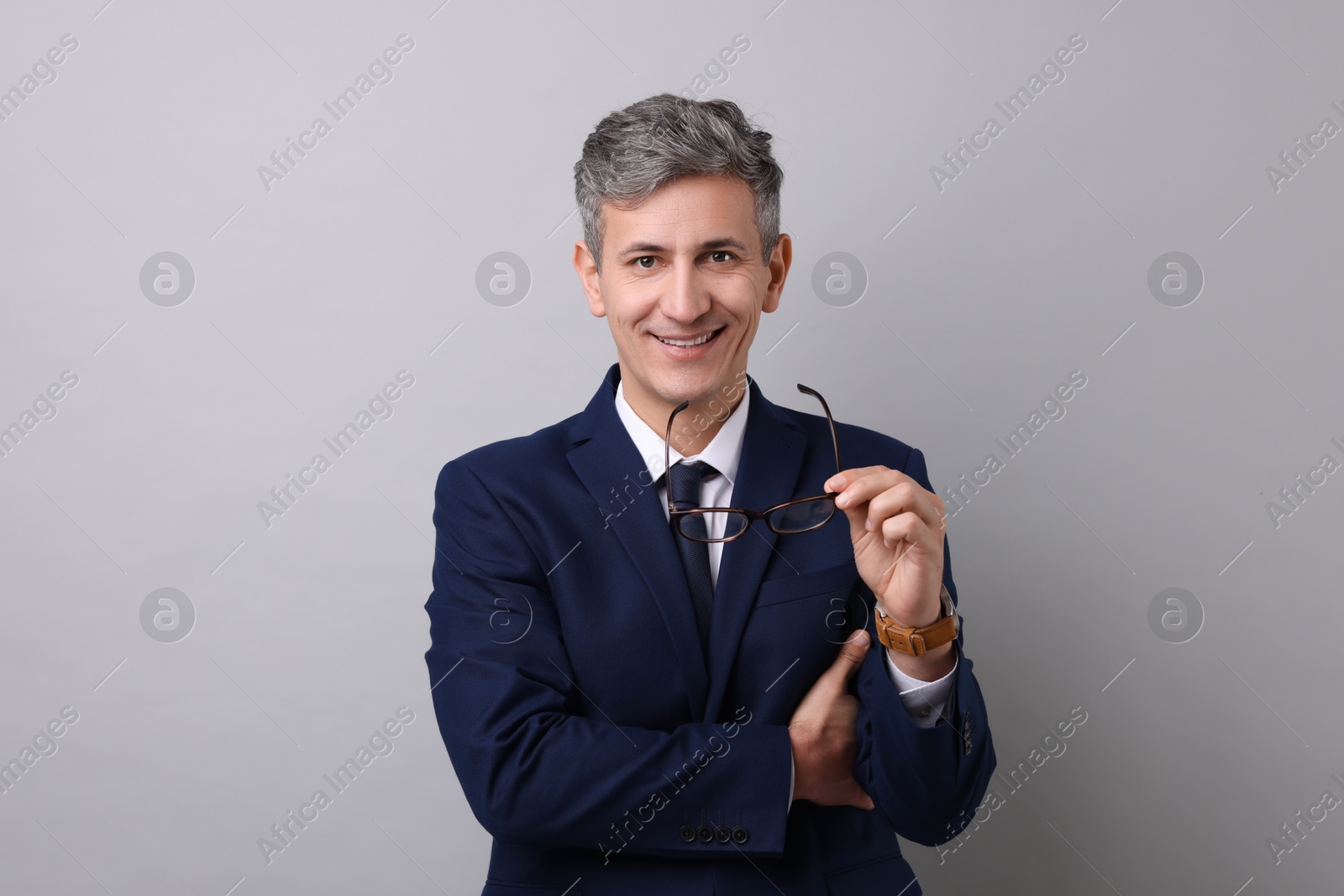 Photo of Portrait of businessman with glasses on light grey background