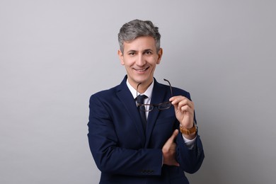 Photo of Portrait of businessman with glasses on light grey background