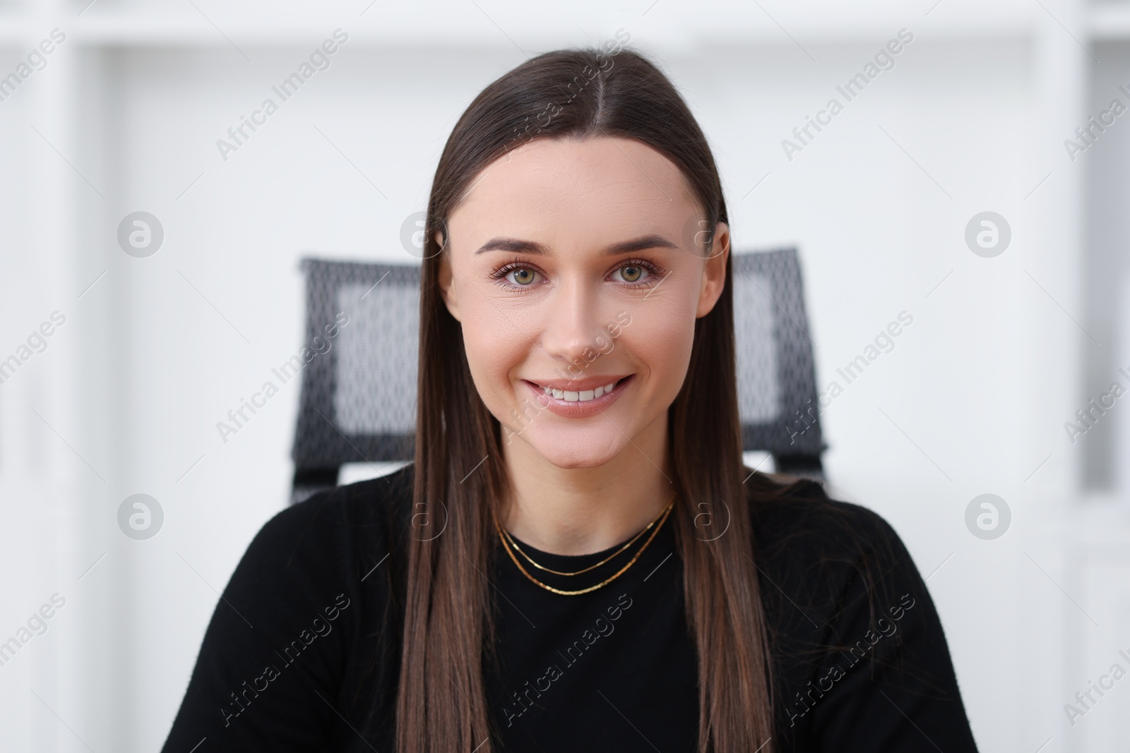 Photo of Portrait of happy beautiful businesswoman in office